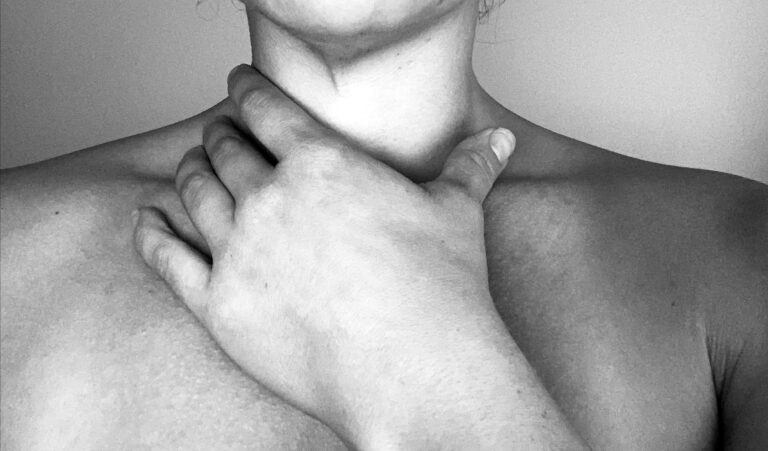 Black-and-white close-up of a hand at the throat – FIT by GP, on living with Hashimoto's